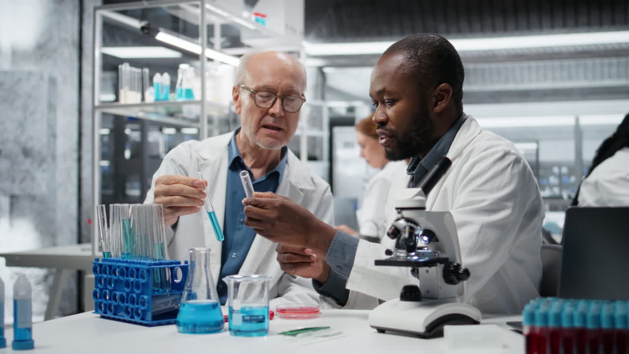 Teamworking molecular biologists in lab evaluate blue compound solution