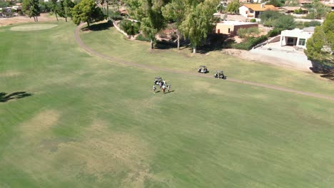 orbiting aerial view of golfers out on the course chatting