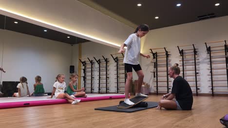 children learning balance on balance board