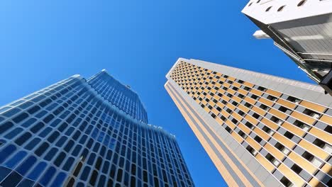 looking-up-impressive-Futuristic-skyscrapers-in-cbd-financial-aera-of-Tokyo,-Shinjuku