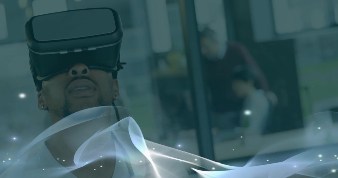 Animation of moving wave over african american men using vr headset