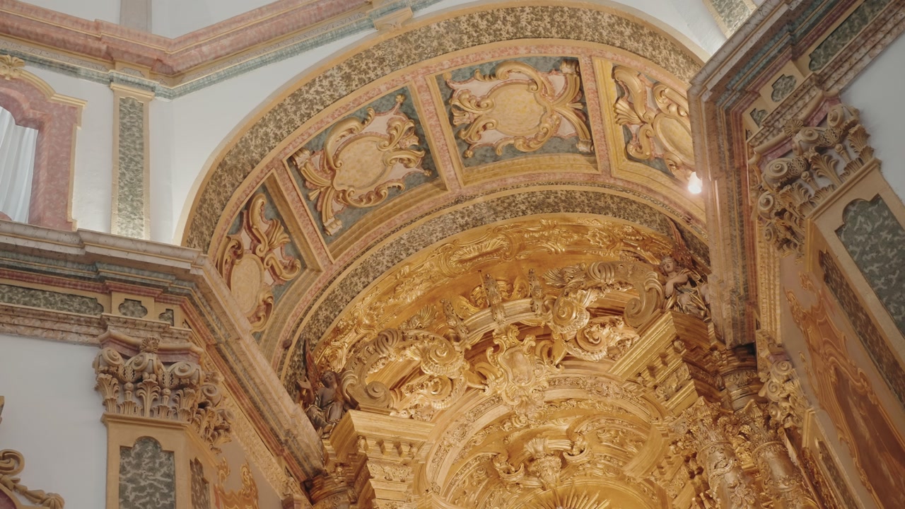 ornate baroque golden ceiling with intricate carvings in catholic church