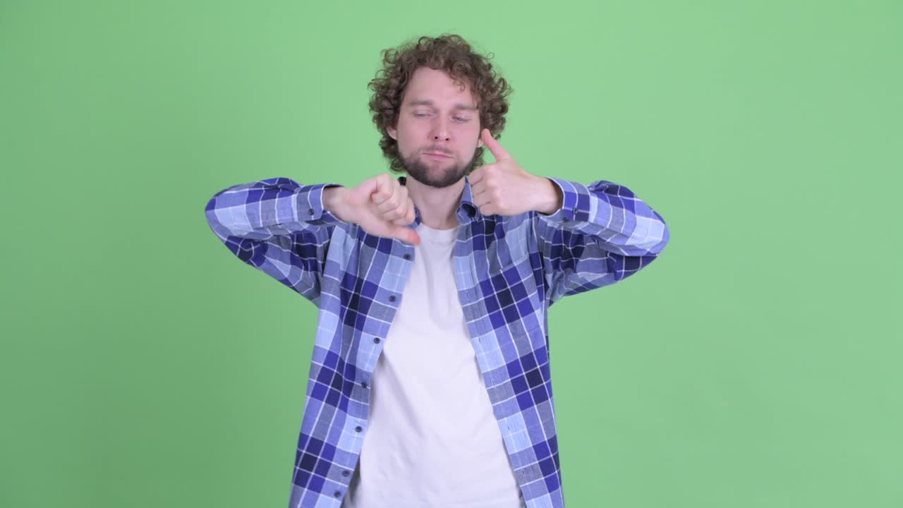 Young handsome bearded hipster man with curly hair