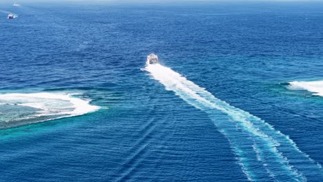 drone shot of ferry boat sailing between moorea and tahiti island, french polynesia