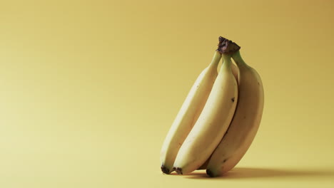 video of bananas with copy space over yellow background