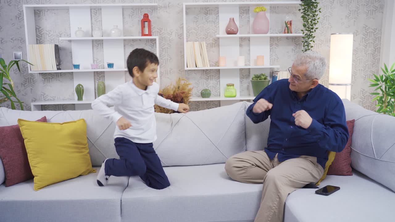 Father and son dancing at home.