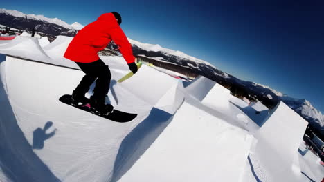 snowboarder performing tricks in a snow park