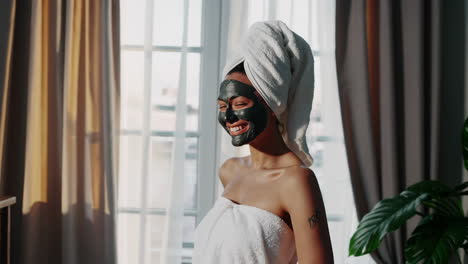 woman applying face mask at home