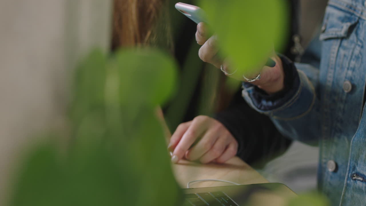 mano a mano usando teléfonos inteligentes estudiantes compartiendo ideas trabajando juntos joven ayudando a un amigo mostrando solución en tecnología de teléfono móvil