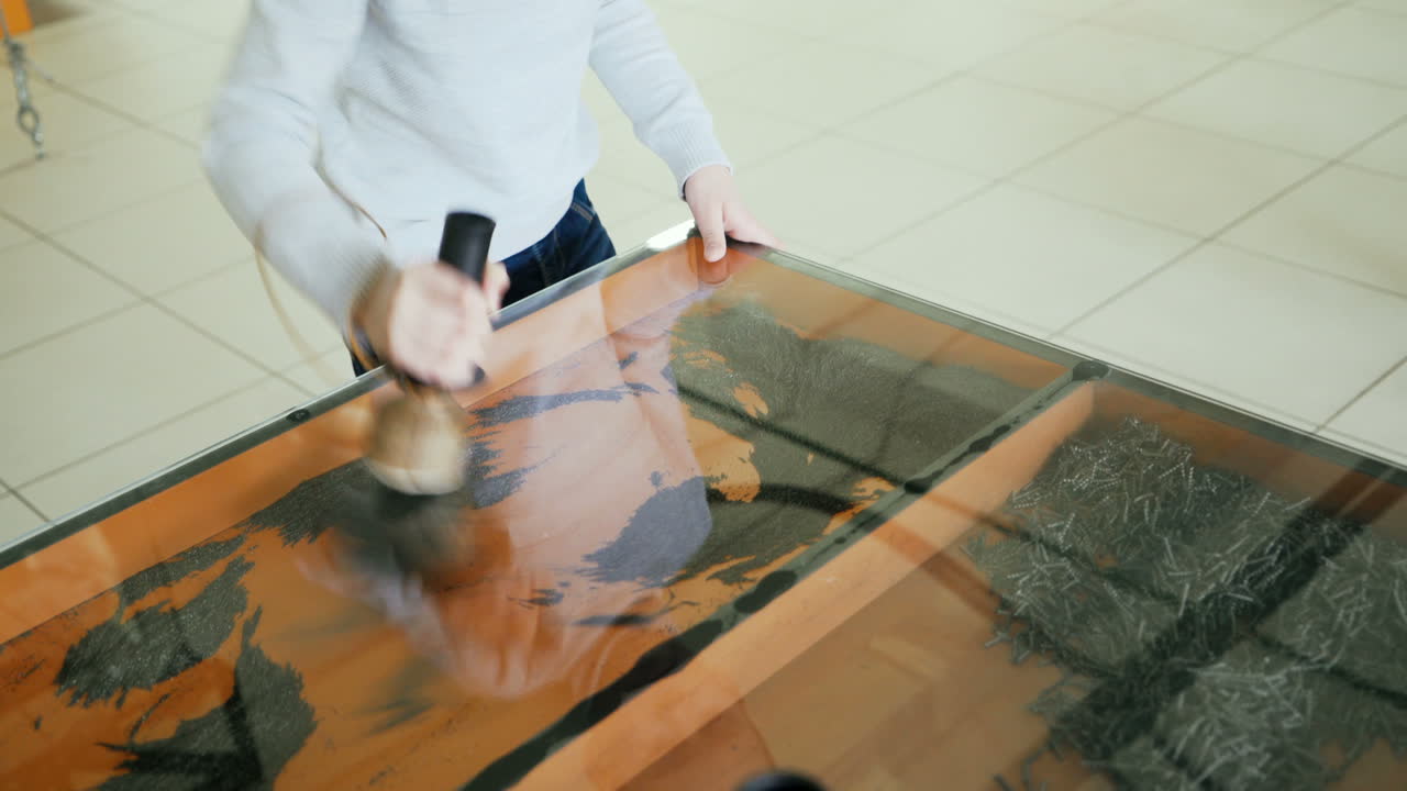 Iron filings in a magnetic field. Boy conducts research experience.