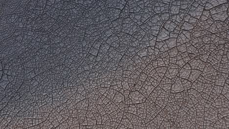 aerial of cracked soil ground of dried lake, arid mud flats, iceland