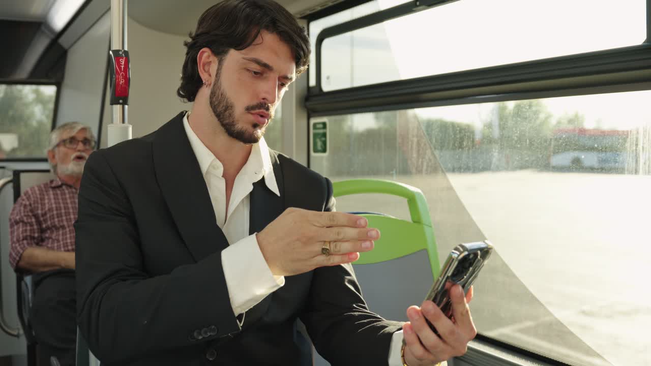 Man in Suit Using Phone on Bus