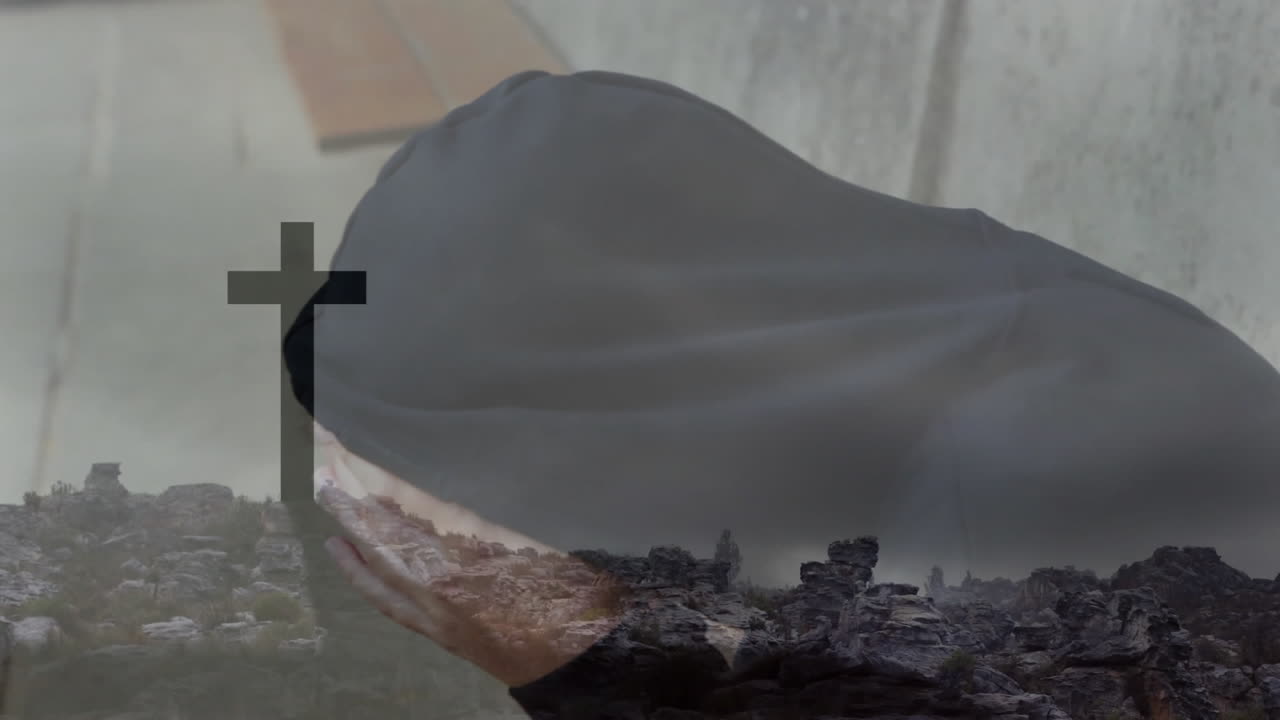 Praying with cross overlay, person in spiritual reflection on rocky landscape