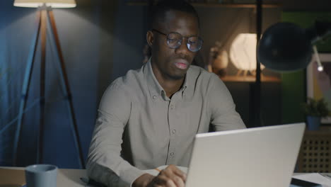 man working late on laptop