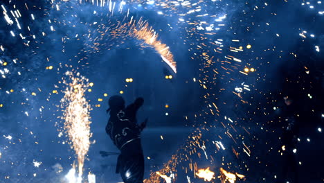 Fantastic firework show performed by a male artist. Dancer waves the object producing the firework from the sides.