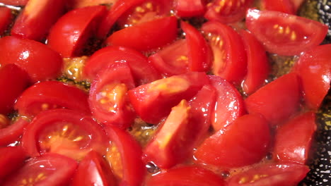 cooking tomatoes in oil in a pan