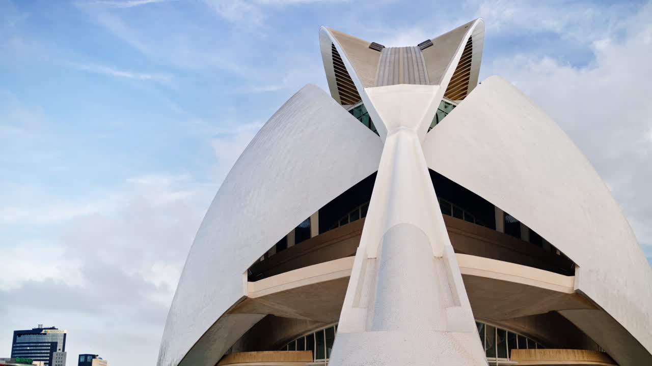 Valencia, Spain - May 28, 2025: Low angle close up of the Palau de les Arts white concrete shells and fins against a cloudy sky
