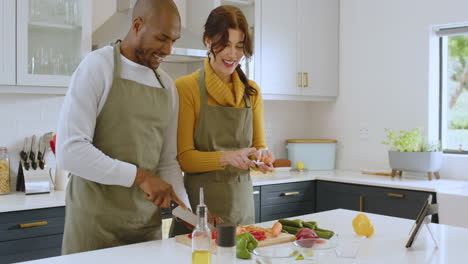 diverse multiracial couple cooking together in modern kitchen, smiling and enjoying moment, at home