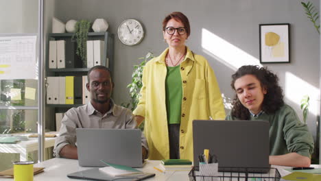 portrait of female business mentor and multiethnic male trainees