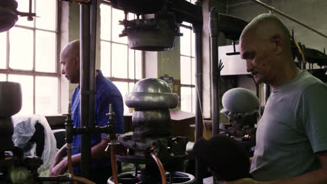 Mixed-race-men-working-at-a-hat-factory