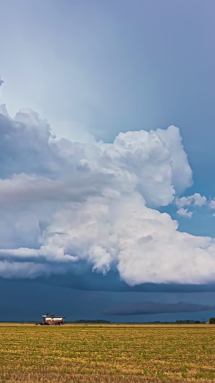 Timelapse of towering storm clouds over a Latvian field, capturing dramatic skies and rural scenery