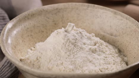 cook sifting flour in a bowl