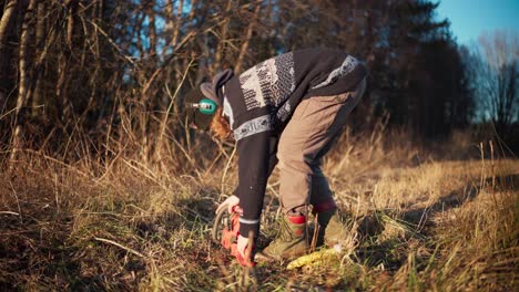 a man is activating the trigger switch on the chainsaw - static shot