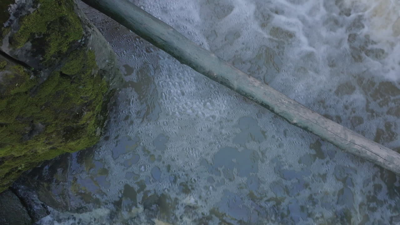 Flowing water over rocks at Rockway Falls in Ontario, Canada, with bubbles