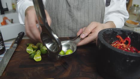 squeezing lime juice into the black bowl