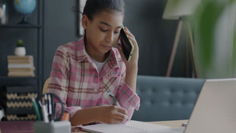girl student talking on phone and studying