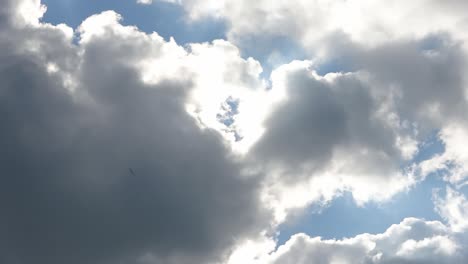 time lapse view at bright sunbeams with some lens flares and clouds in the sky.