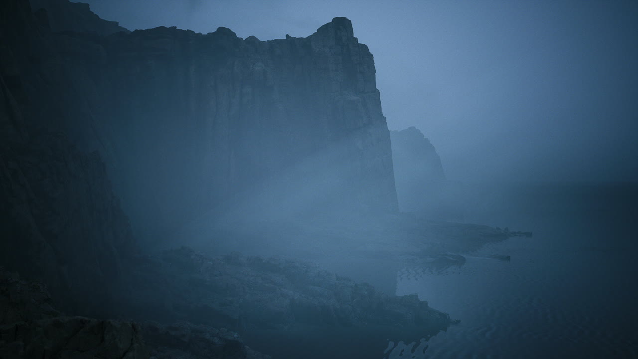 Dark cliffs shrouded in mist create a mysterious coastal atmosphere