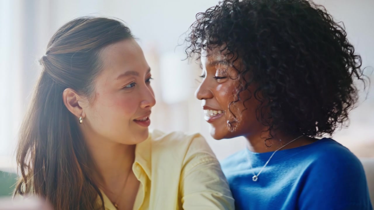 Multiracial women taking selfie phone home closeup. Girlfriend embracing smiling