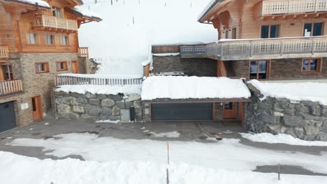 Drone-flying-out-from-a-hot-tub-and-revealing-a-beautiful-chalet-in-a-snow-covered-landscape