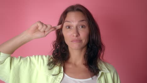 woman pointing to her head