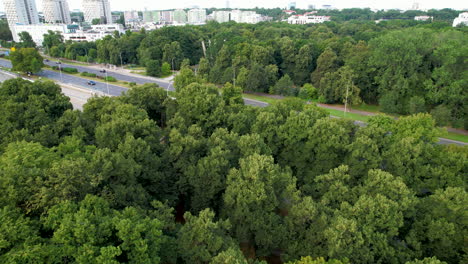 aerial flyover forest and highway of warsaw with residential area in background in suburb area