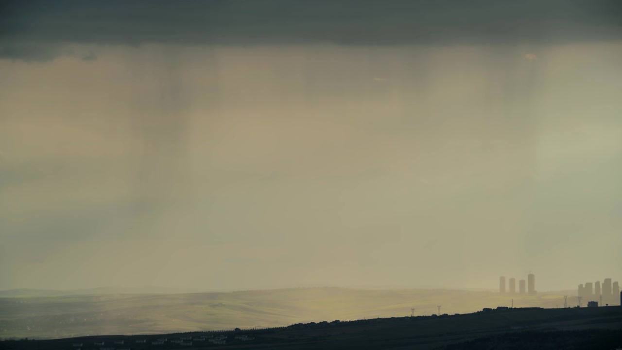 Rain Falling Over Distant Hills and City Skyline