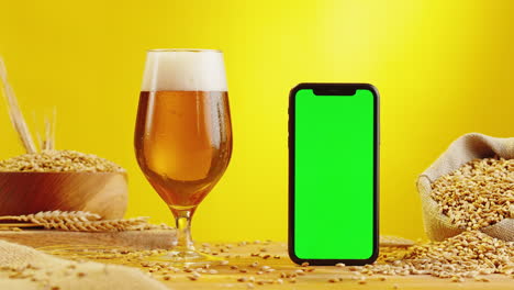 beer and mobile phone with green screen