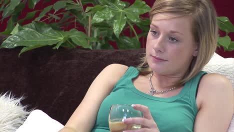 woman on sofa relaxing with a glass of wine