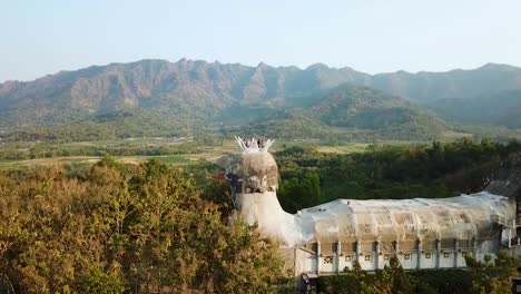 Aerial-side-view-of-Chicken-church-and-Menoreh-hills-in-Muntilan-Indonesia