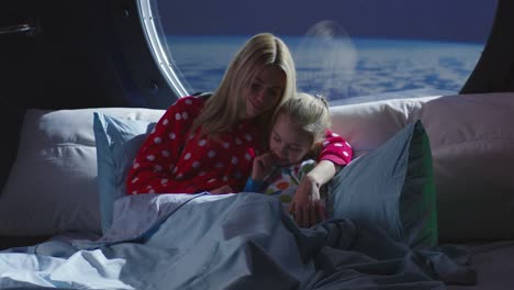 mother and daughter sleeping in space