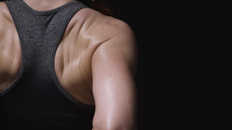 Close Up Studio Shot Showing Back Of Mature Woman Wearing Gym Fitness Clothing Doing Stretching Exercises 2