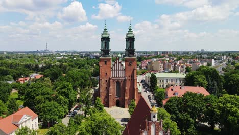 poznań cathedral rises majestically, greenery and historic city skyline, drone