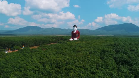 incredible massive buddha aerial statue asia countryside rubber trees orbit drone