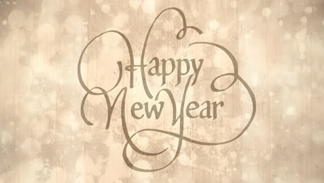 cinemagraph of happy new year text in decorative font over moving glowing golden light spots
