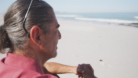 Portrait-of-a-senior-Caucasian-man-enjoying-time-on-the-beach