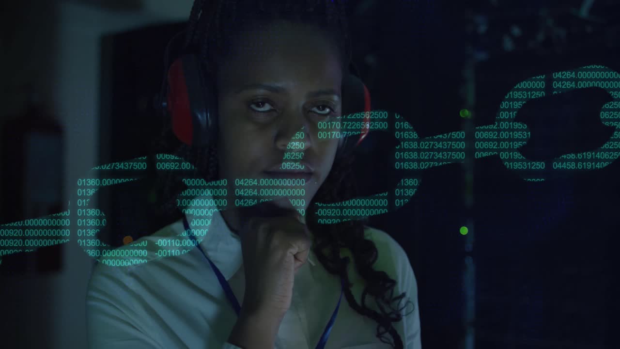Animation of digital chain over biracial woman using headphones in server room