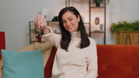 woman real estate agent showing the keys of new home house apartment buying or renting property