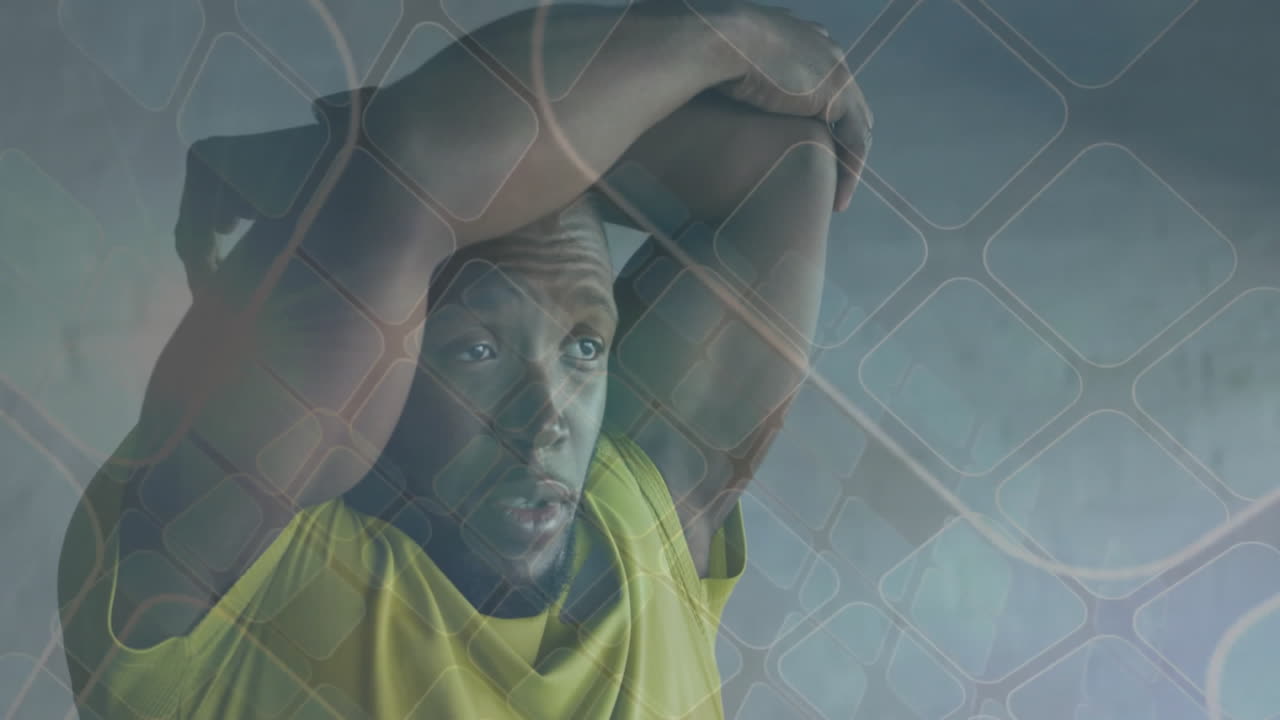 Resting athlete with arms over head, animation of geometric pattern overlay