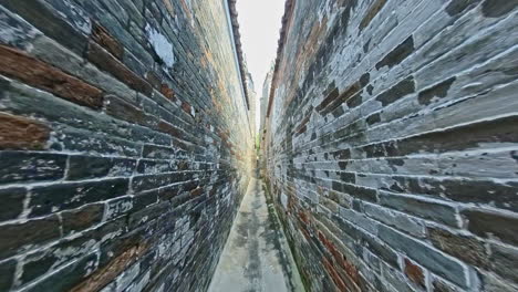 narrow brick wall path in yuen long, hong kong